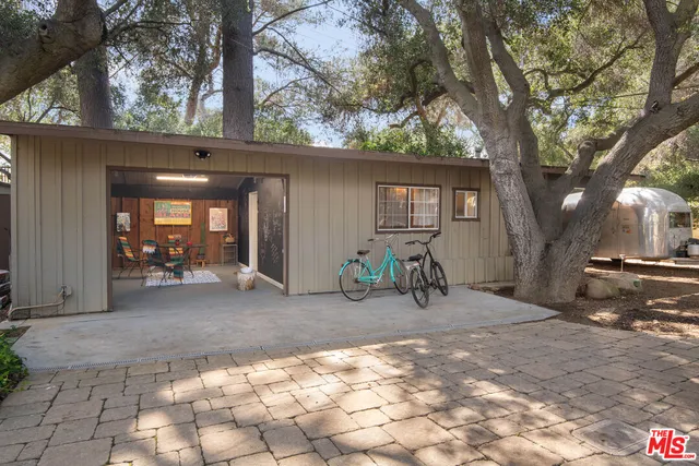 a view of a dining room with furniture and a chandelier