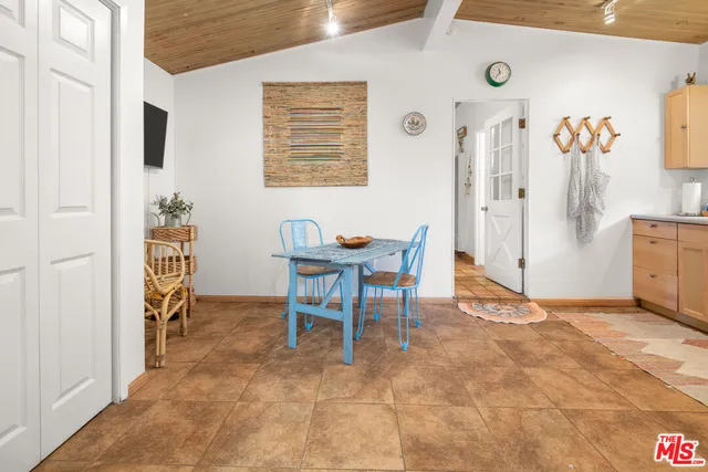 a dining room with furniture and a flat screen tv