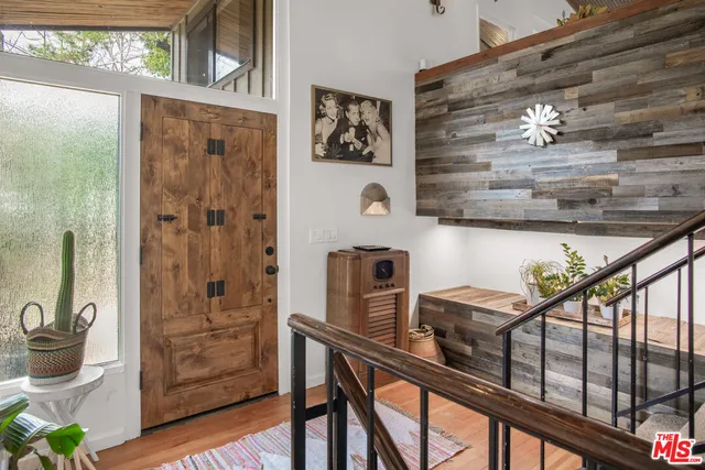 a dining hall with stainless steel appliances granite countertop a dining table and chairs with wooden floor