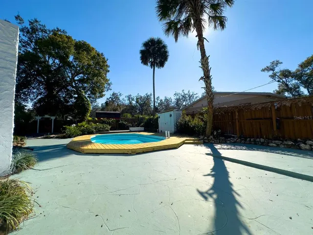 a view of a swimming pool with a yard