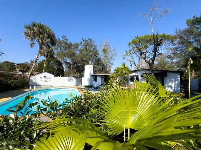 a view of a swimming pool with a yard