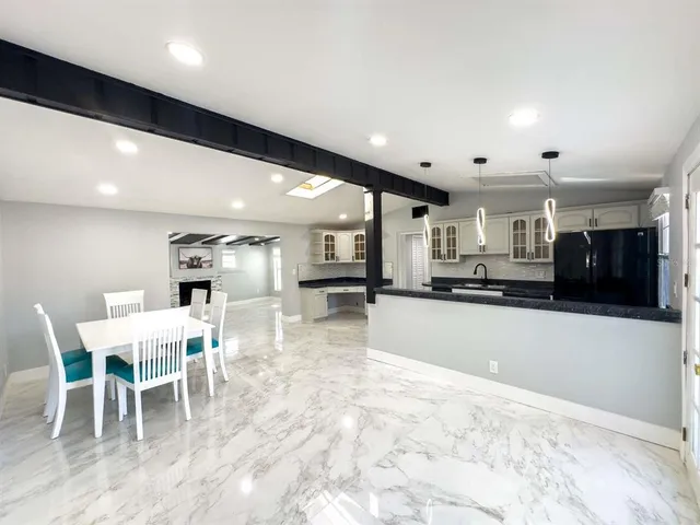 a large kitchen with a table and chairs