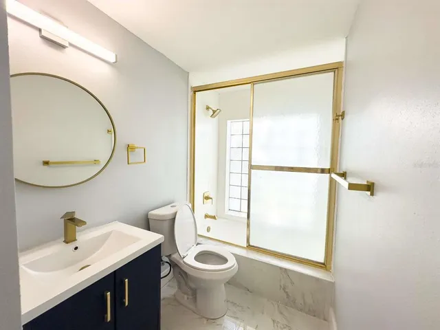 a bathroom with a toilet a sink and a mirror