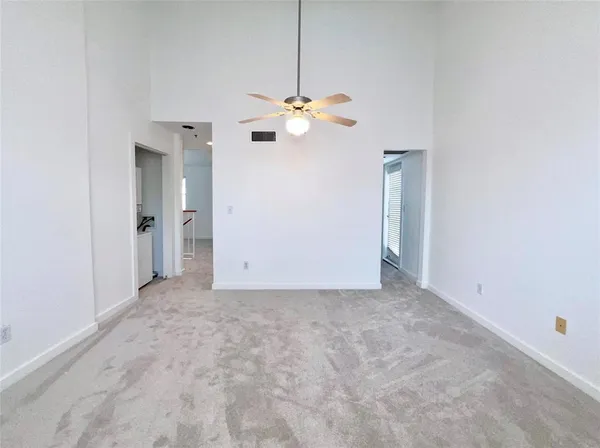 a view of an empty room with a fan