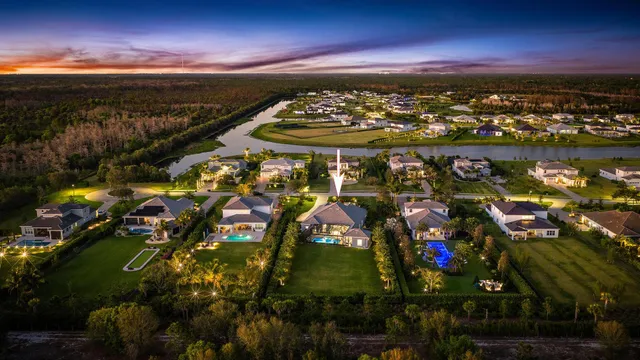 a view of a house with swimming pool and sitting area