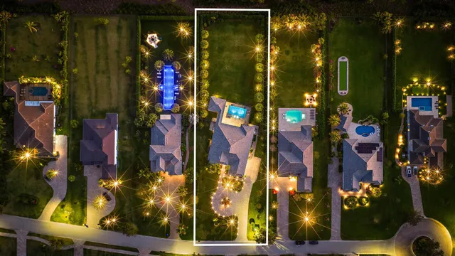 an aerial view of residential house with outdoor space and swimming pool