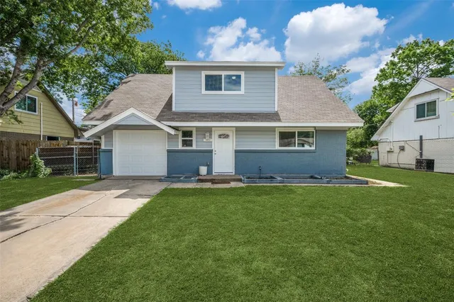 a front view of house with yard and outdoor seating