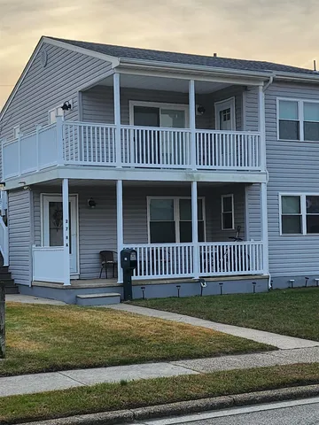 a view of a house with a small deck
