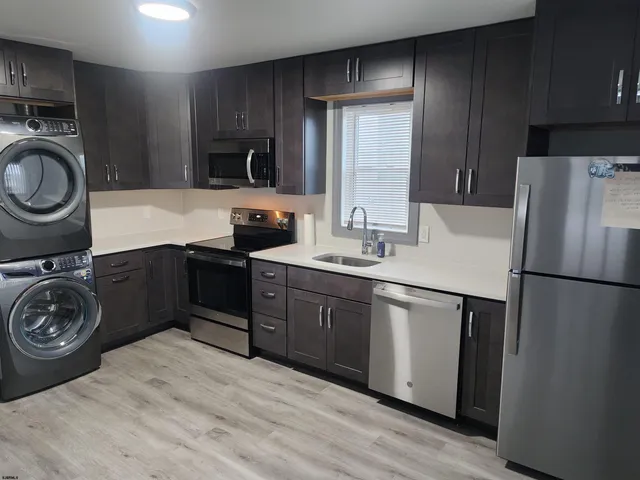 a kitchen with a refrigerator and a sink