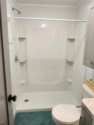 a bathroom with a toilet and a shower