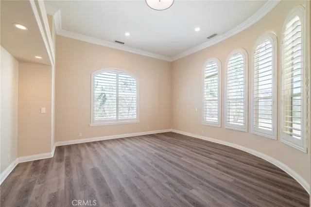 a view of a room with wooden floor and windows