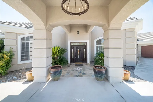 an empty room with wooden floor fireplace and windows