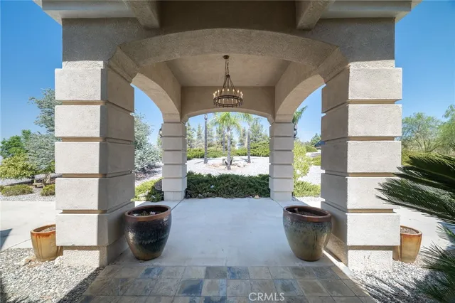 an empty room with wooden floor fireplace and windows