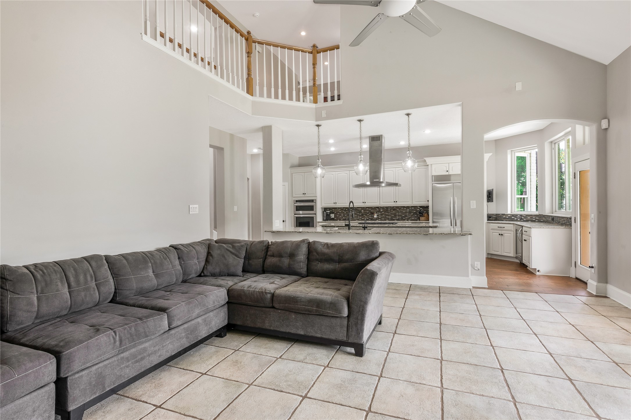 13914 Skinner Road Cypress, TX 77429 - Photo 11 of 50 Open living area with high ceilings, tile floors, and a clear view into the kitchen and breakfast area.