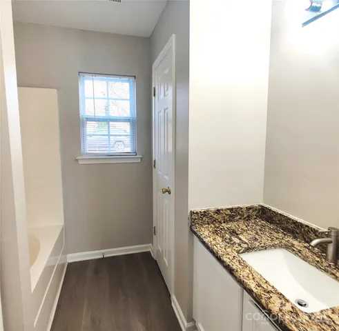 a bathroom with a granite countertop sink and a granite