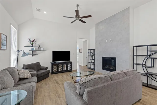 a living room with furniture and a view of kitchen