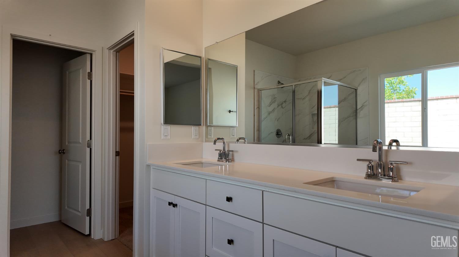 Undisclosed Address Bakersfield, CA 93311 - Photo 15 of 31 a bathroom with double vanity sinks and a mirror