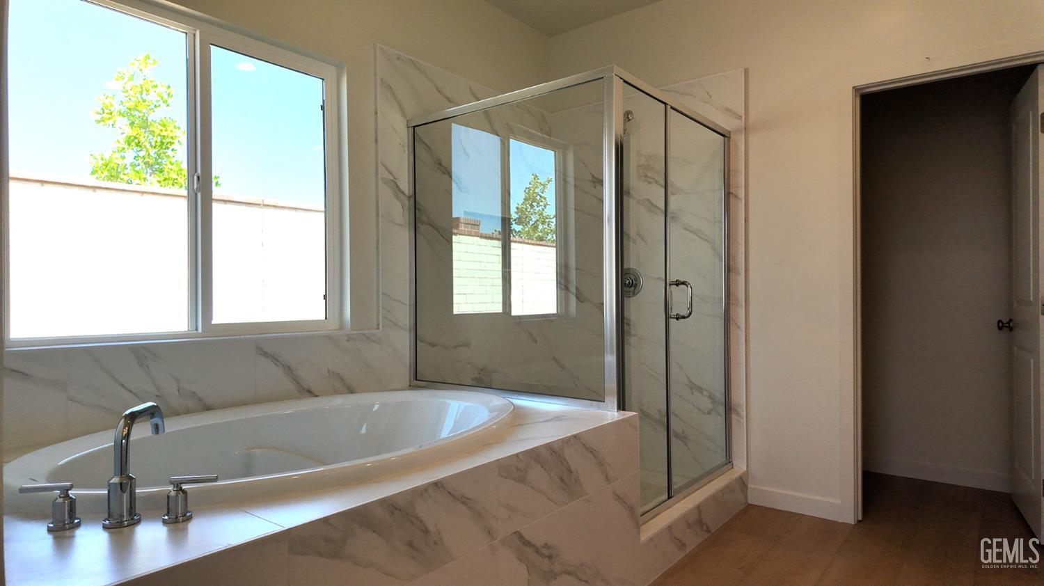 Undisclosed Address Bakersfield, CA 93311 - Photo 16 of 31 a bathroom with a bathtub and a shower