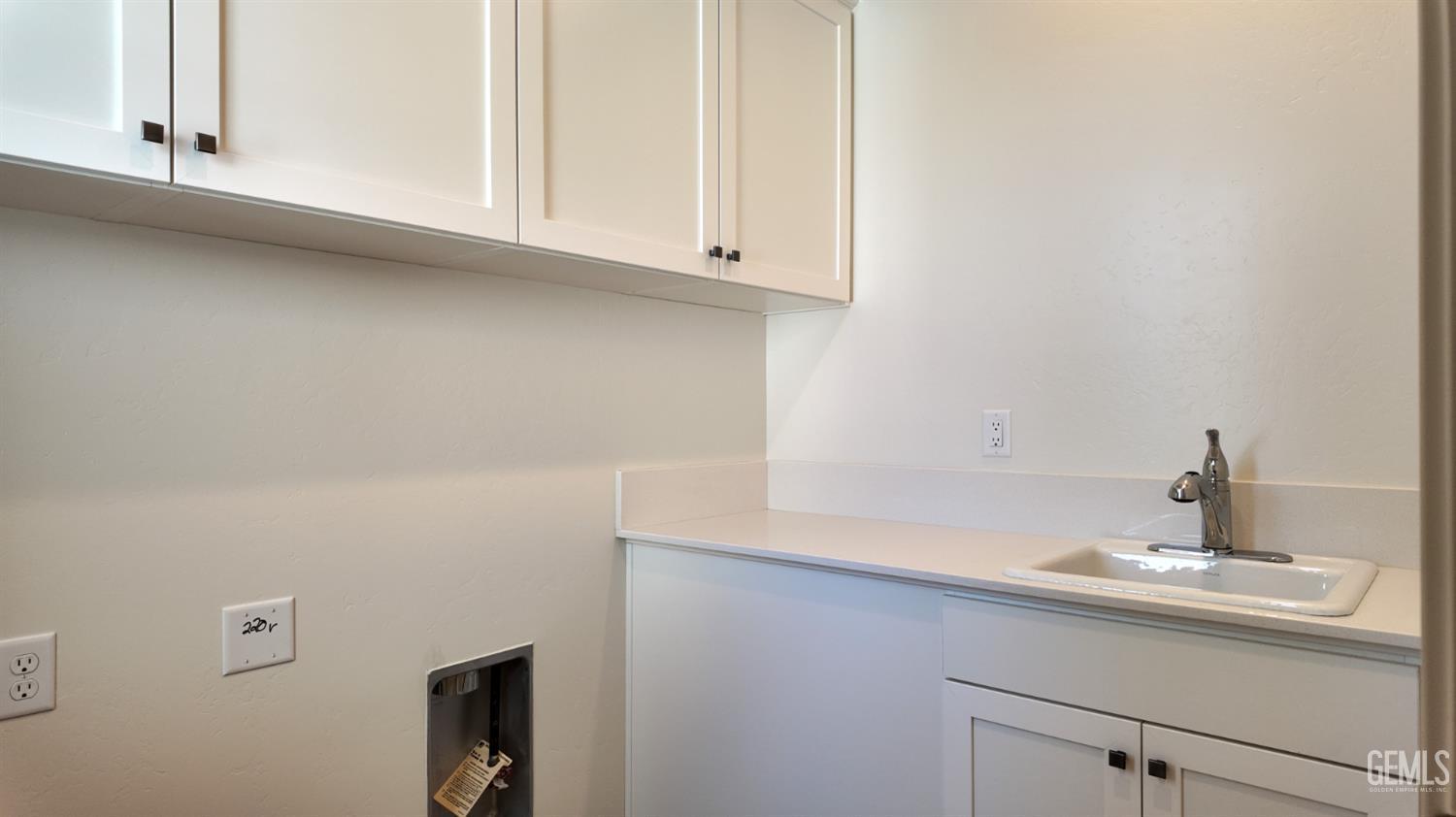 Undisclosed Address Bakersfield, CA 93311 - Photo 8 of 31 a bathroom with a sink and cabinets