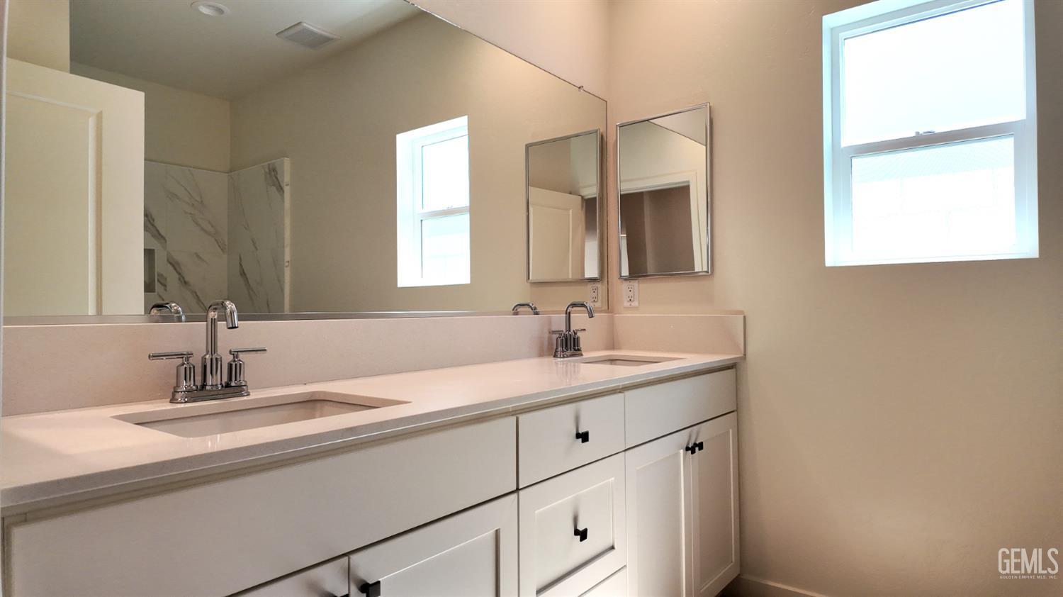 Undisclosed Address Bakersfield, CA 93311 - Photo 10 of 31 a bathroom with a sink and a mirror