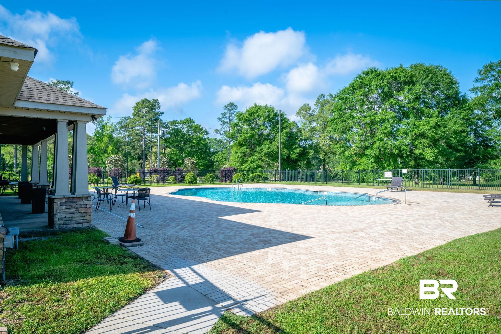 2183 Meadowview Loop Semmes, AL 36575 - Photo 56 of 58 View of swimming pool with patio surround and view of wooded area