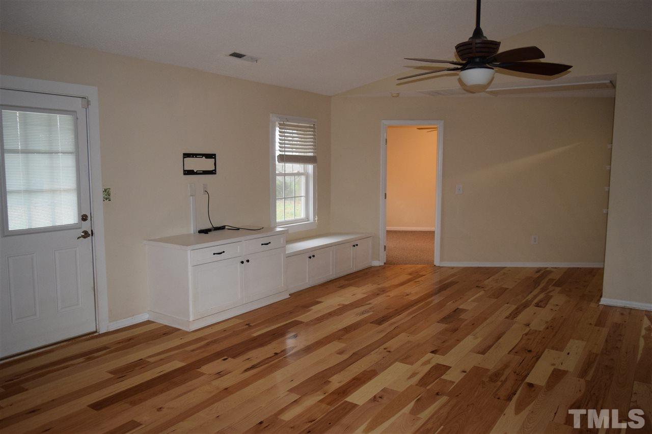 6617 Cassam Road Bahama, NC 27503 - Photo 5 of 20 The great room features beautiful hickory engineered wood flooring and built-in cabinets.