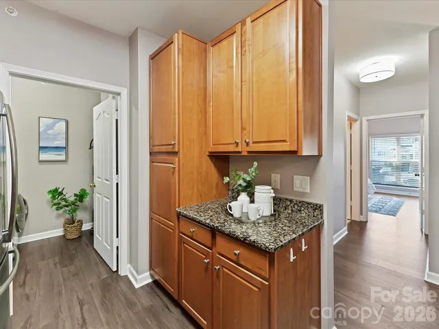 a kitchen with granite countertop stainless steel appliances a counter space and wooden floor