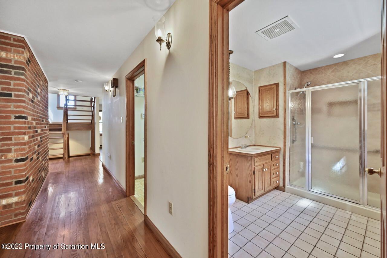 2181 Becks Crossing Road Moscow, PA 18444 - Photo 21 of 70 a bathroom with a glass door shower and a sink