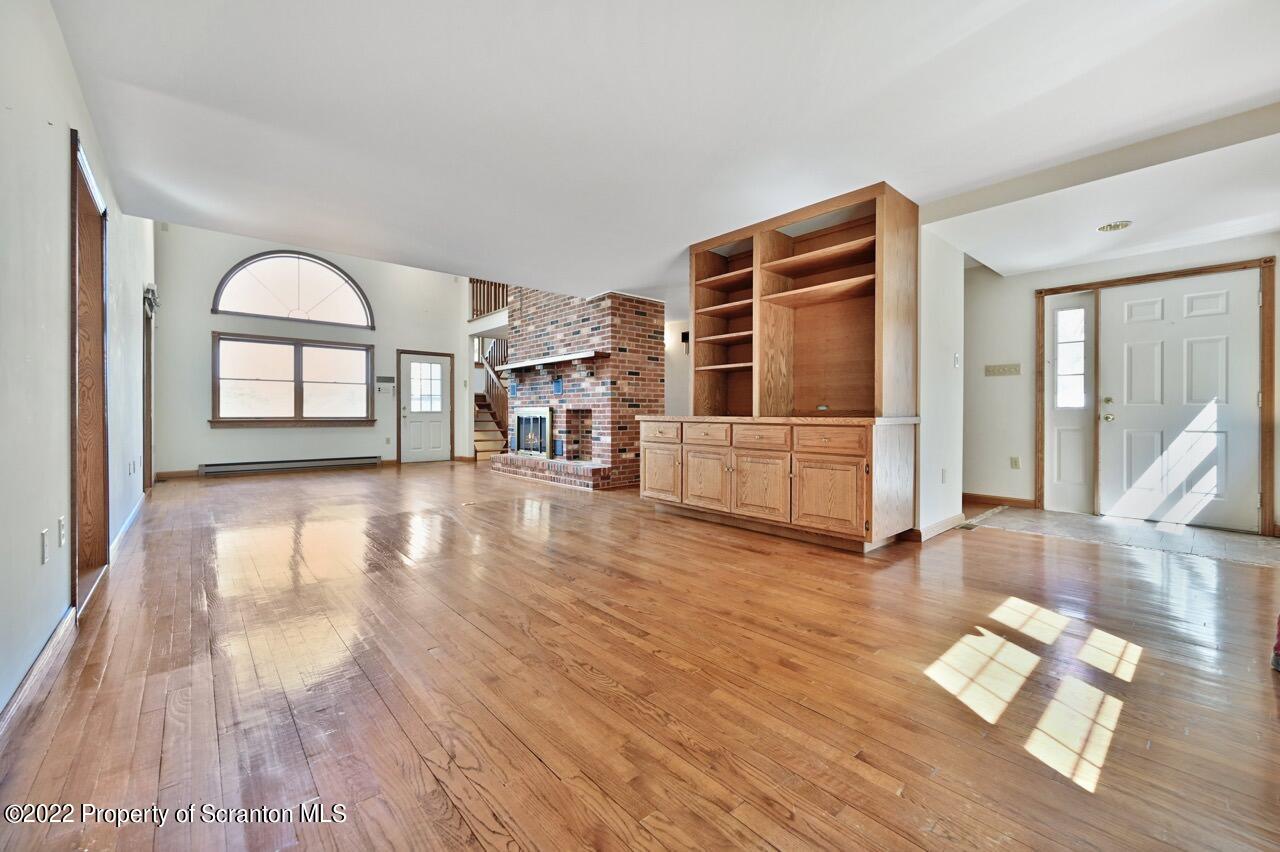 2181 Becks Crossing Road Moscow, PA 18444 - Photo 7 of 70 a view of a livingroom with wooden floor and furniture