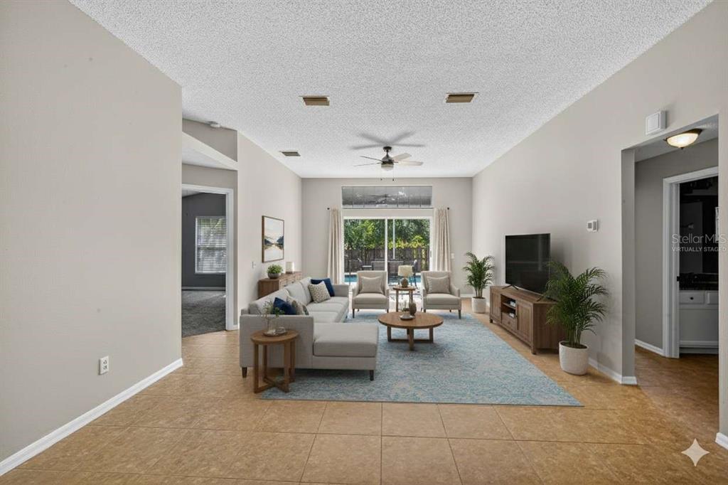 12630 Early Run Lane Riverview, FL 33578 - Photo 3 of 14 a living room with furniture and a flat screen tv