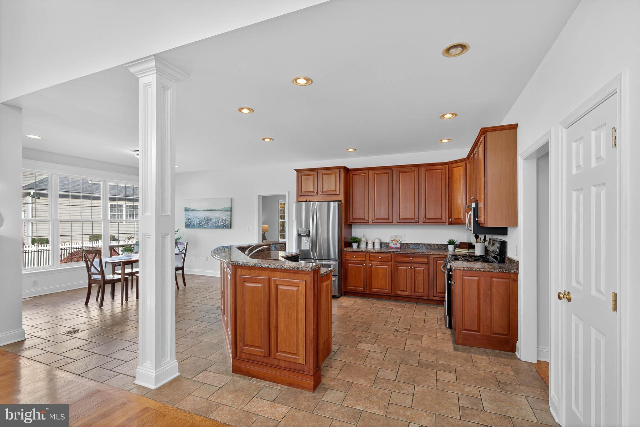 304 Cobblers Court Lititz, PA 17543 - Photo 12 of 50 a kitchen with a stove a refrigerator and chairs