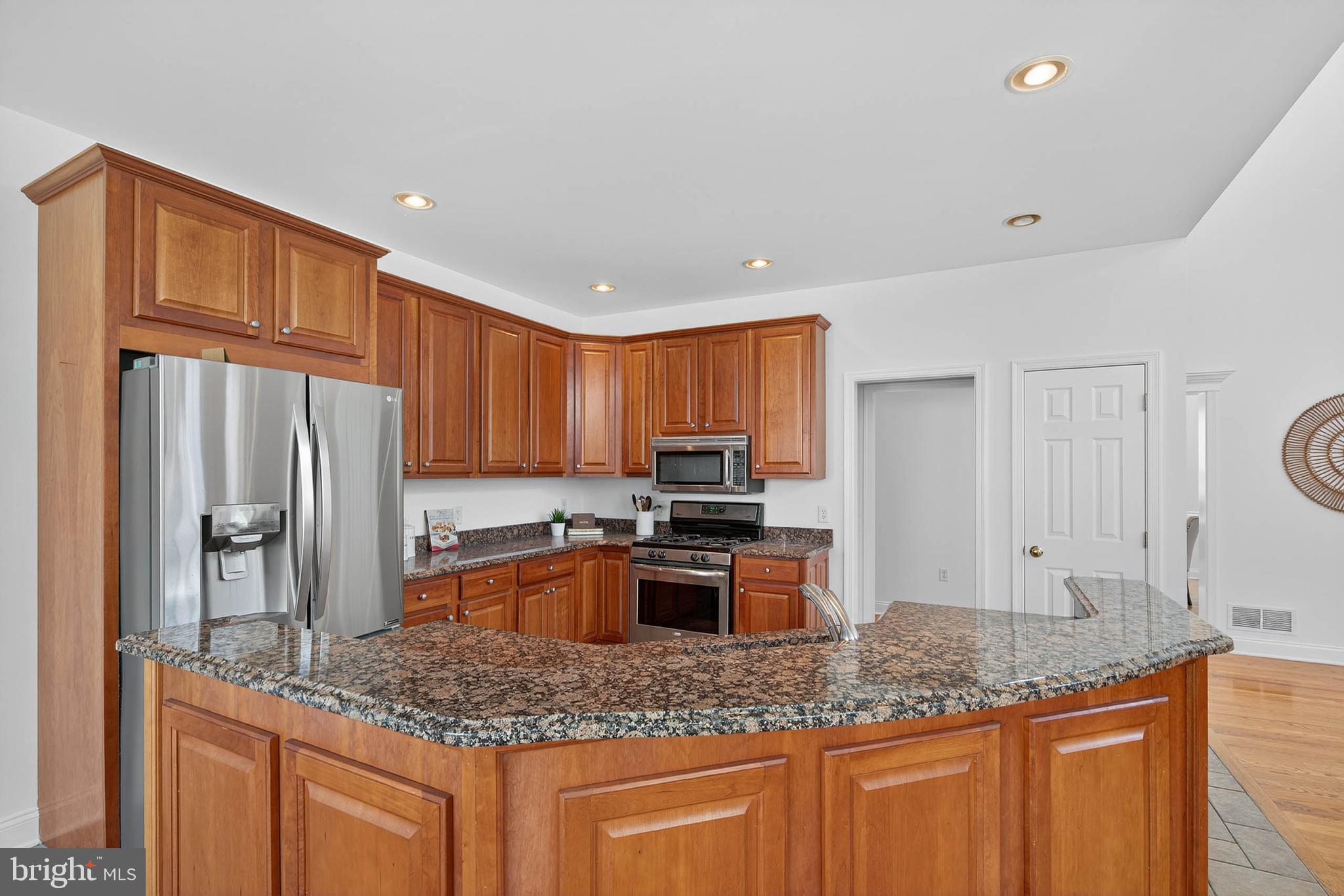 304 Cobblers Court Lititz, PA 17543 - Photo 14 of 50 a kitchen with stainless steel appliances granite countertop a sink stove and refrigerator