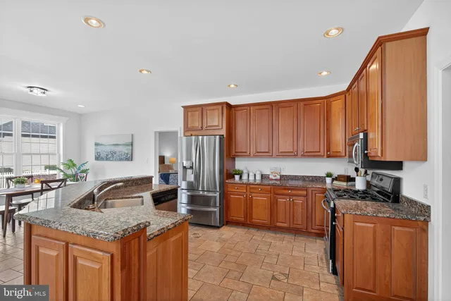 a kitchen with granite countertop a sink and cabinets