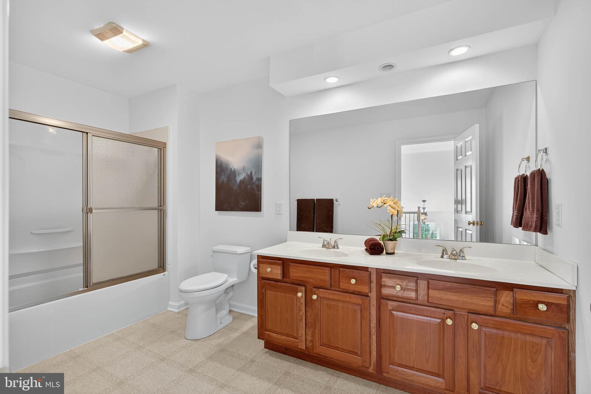 304 Cobblers Court Lititz, PA 17543 - Photo 32 of 50 a spacious bathroom with a double vanity sink a mirror and a toilet
