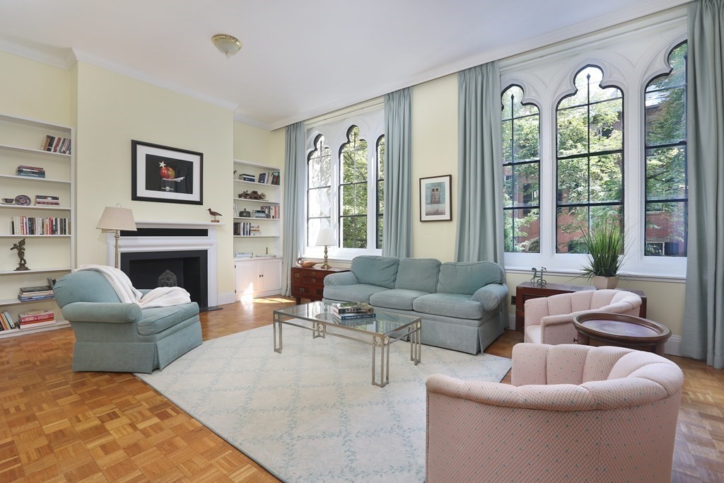 a living room with furniture a large window and a fireplace