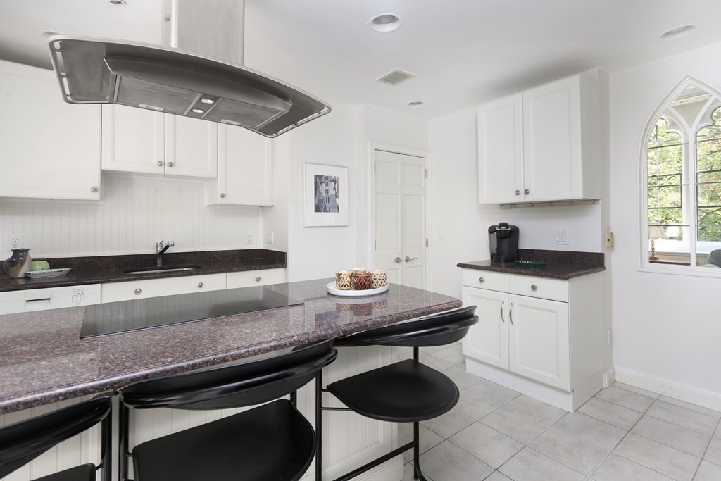 27 Chestnut Street, Unit 1B Boston, MA 02108 - Photo 8 of 14 a kitchen with stainless steel appliances a sink a stove and white cabinets