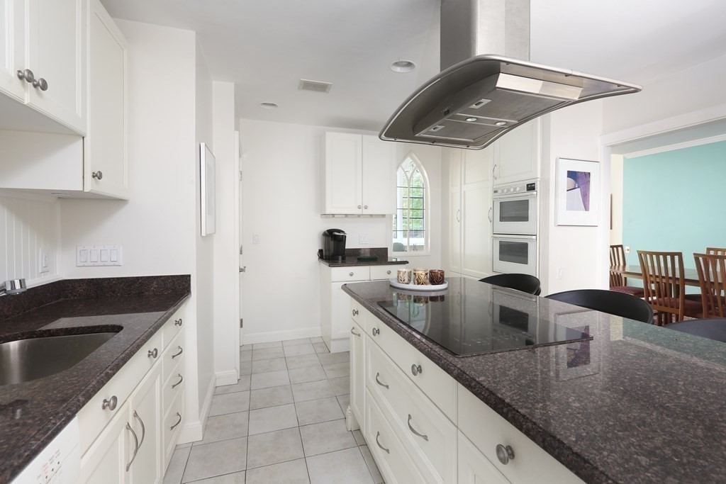 27 Chestnut Street, Unit 1B Boston, MA 02108 - Photo 9 of 14 a kitchen with granite countertop a sink a counter top space and cabinets