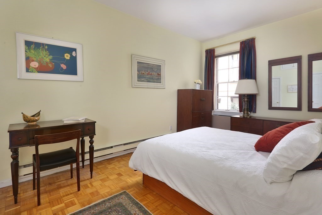 27 Chestnut Street, Unit 1B Boston, MA 02108 - Photo 10 of 14 a bedroom with a bed and a table in it
