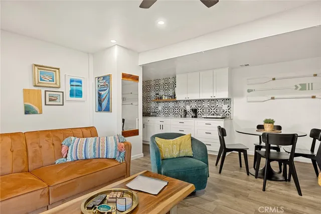 a living room with furniture and a kitchen view