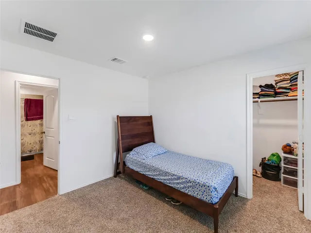 a bathroom with a granite countertop sink a toilet and a mirror
