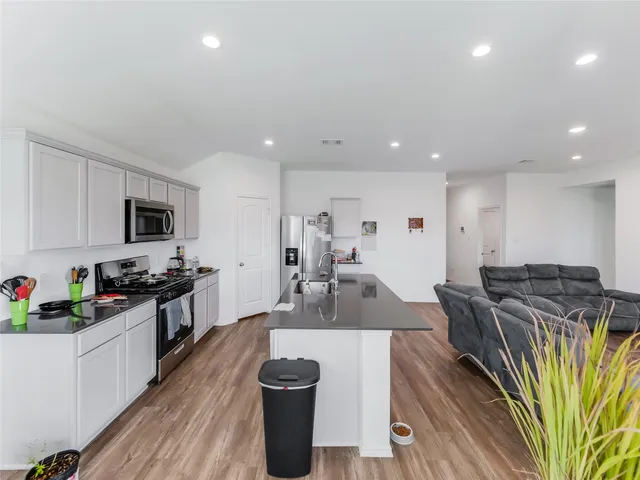 a en suite bathroom with a granite countertop sink and a mirror