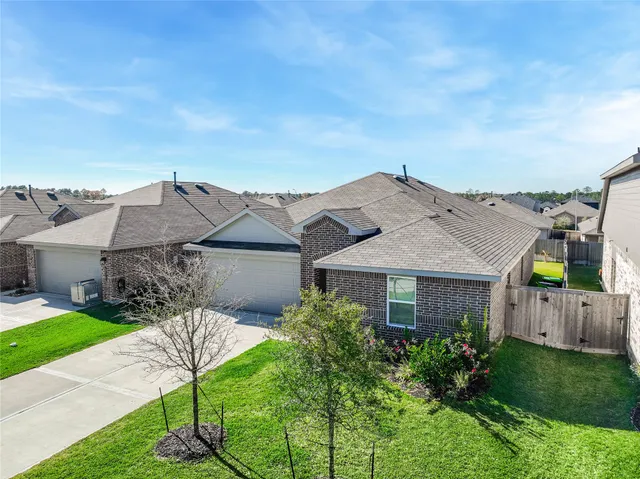 an aerial view of a house with a yard and potted plants
