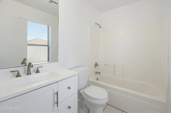 a bathroom with a sink toilet vanity and bathtub