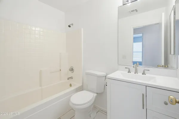 a bathroom with a sink toilet vanity and bathtub