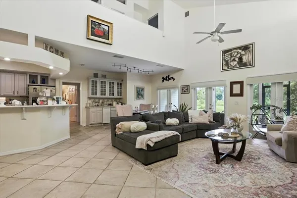 a living room with furniture and kitchen view