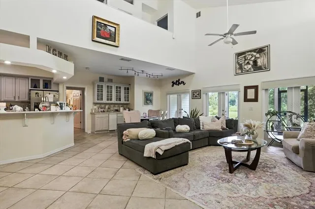a living room with furniture and kitchen view