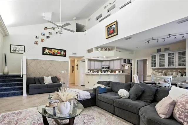 a living room with furniture and kitchen view