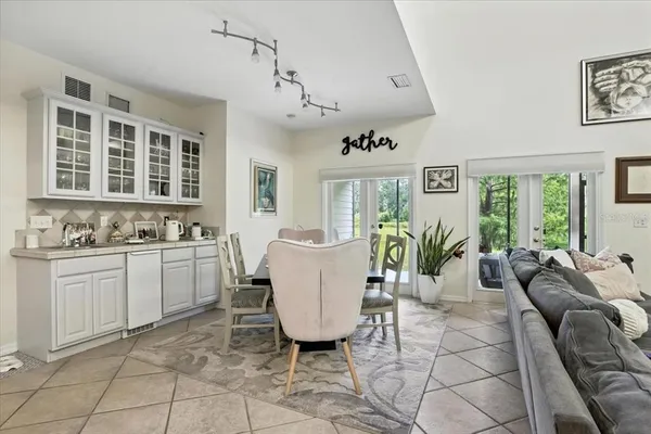 a living room with furniture a window and a kitchen view