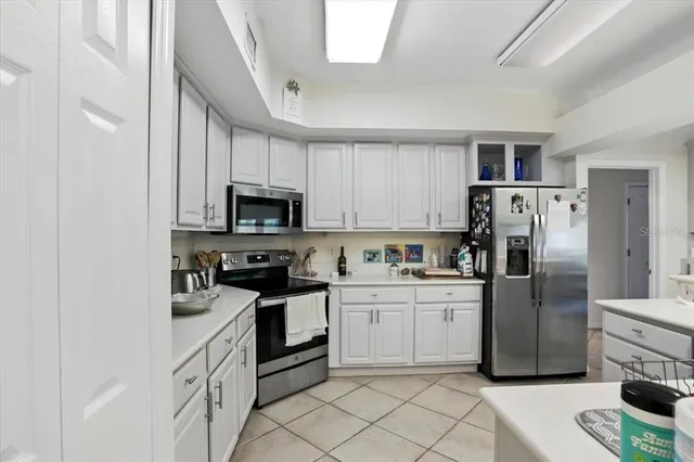 a kitchen with white cabinets and stainless steel appliances