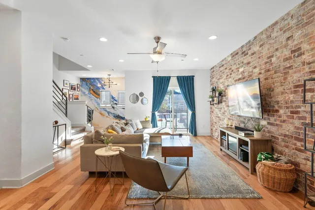 a living room with fireplace furniture wooden floor and a rug